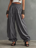 Full size smocked ruffle hem wide-leg pants from Trendsi, featuring flowing fabric and stylish ruffle details at the hem.