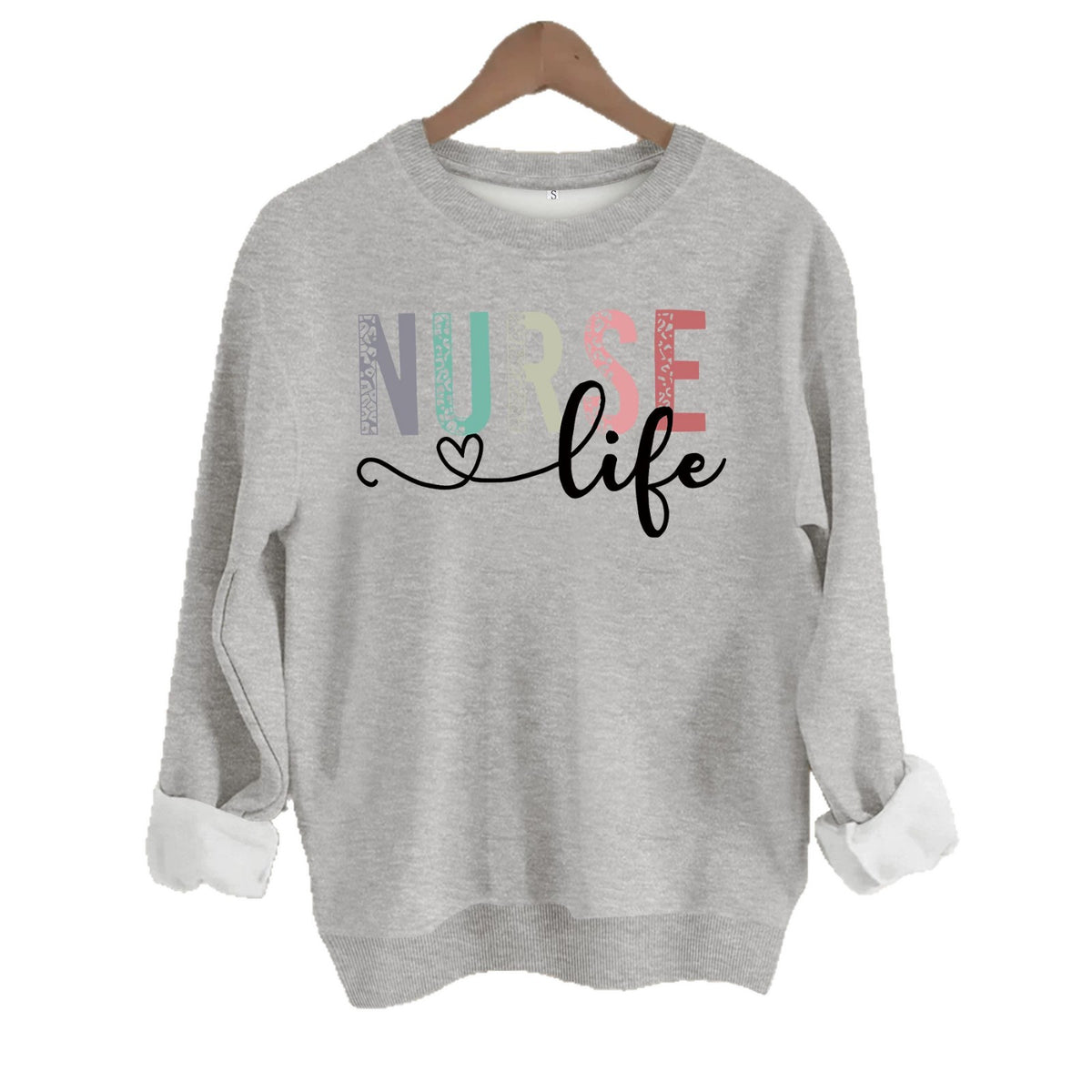 Grey crewneck sweatshirt featuring "NURSE life" in multicolored leopard-print block letters and black script.