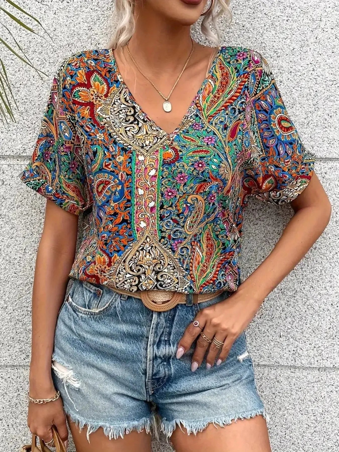 Plush Fashion Hub bohemian paisley V-neck short sleeve T-shirt with vibrant pattern and relaxed fit, displayed on a plain background.