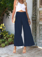 Women's lightweight wide-leg casual trousers with smocked waist, comfortable and stylish pants by Trendsi.