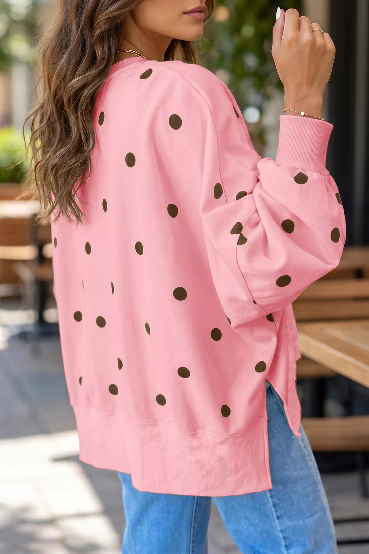 Oversized polka dot sweatshirt with side slit from Trendsi, featuring a relaxed fit and stylish black and white pattern.