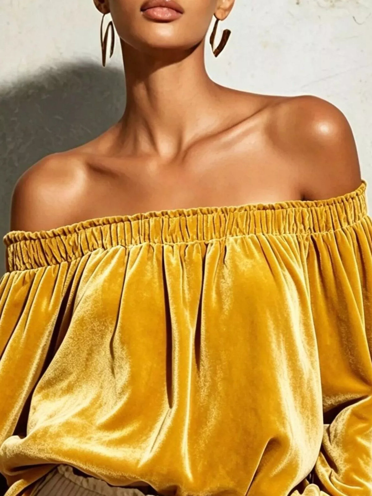 Off-shoulder velvet long sleeve T-shirt by Trendsi, featuring a stylish off-shoulder design and soft velvet fabric.