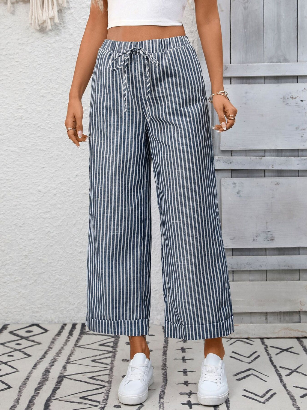Women's striped wide-leg drawstring pants with pockets from Trendsi, featuring a relaxed fit and comfortable waistband.
