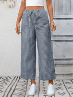 Women's striped wide-leg drawstring pants with pockets from Trendsi, featuring a relaxed fit and comfortable waistband.