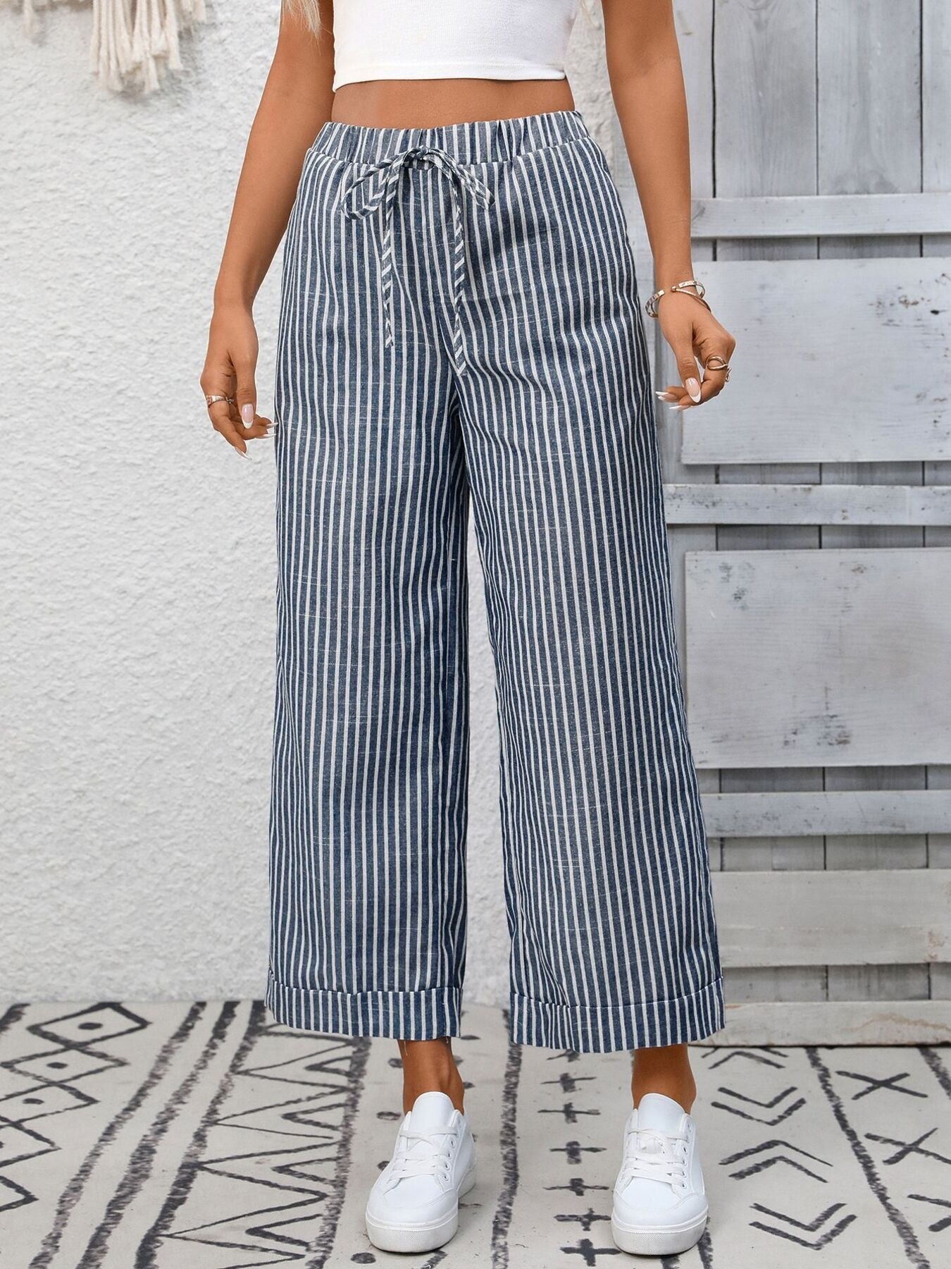 Women's striped wide-leg drawstring pants with pockets from Trendsi, featuring a relaxed fit and comfortable waistband.