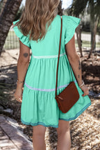 Cotton ruffled notched cap sleeve mini dress from Trendsi featuring a feminine design and stylish ruffle details.