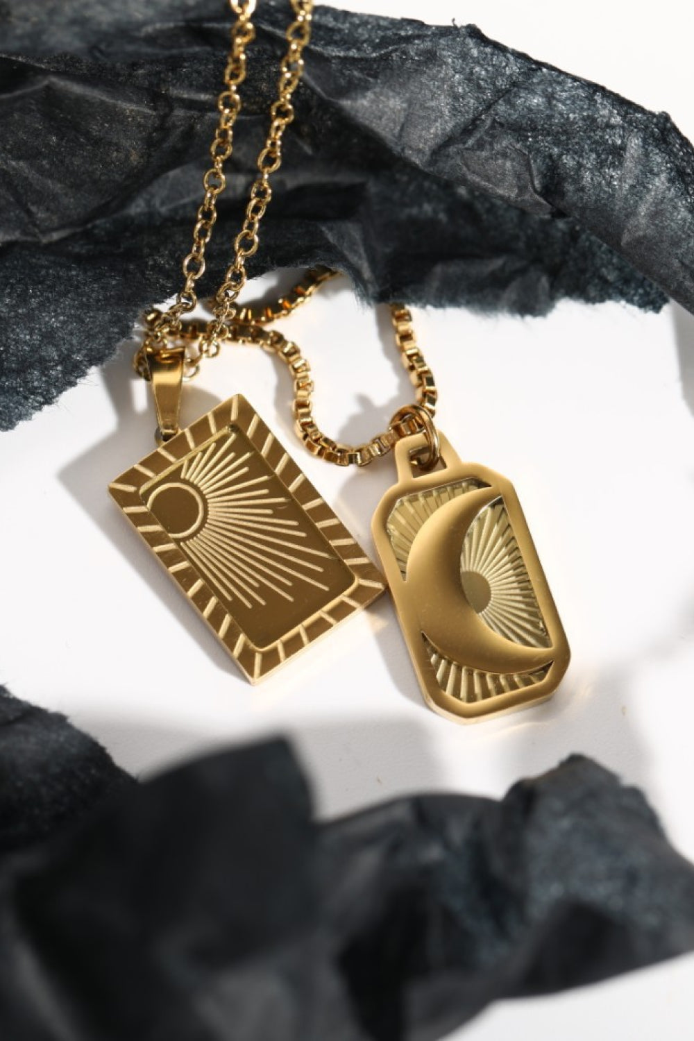 Stainless steel necklace with 18K gold plating featuring a sleek, modern design, displayed on a neutral background.