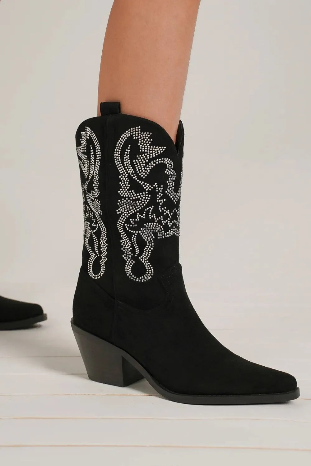 Beast Fashion rhinestone detail point toe boots with sleek black leather and decorative rhinestones, trendy footwear by Trendsi.