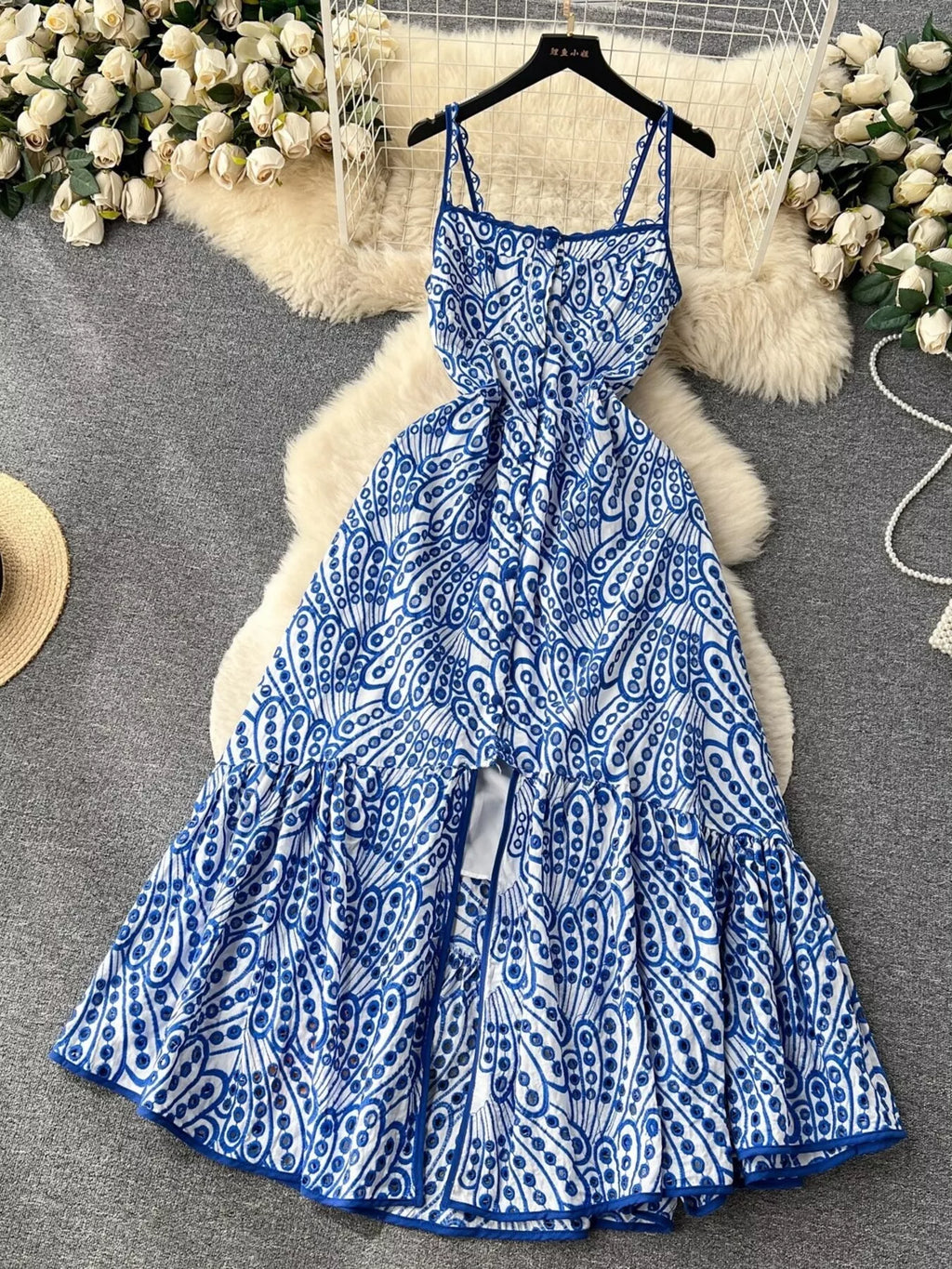 Eyelet embroidered tiered boho midi camisole dress in lightweight fabric, featuring summer-inspired design and floral details.