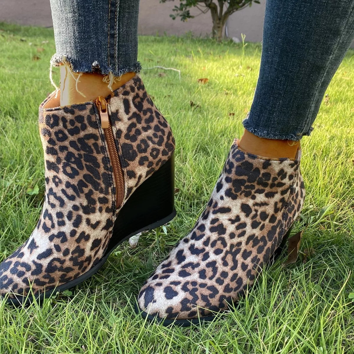 Black round toe wedge ankle boots from Trendsi, featuring a stylish design with a comfortable heel and ankle-length silhouette.