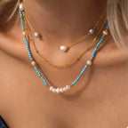 Turquoise pearl beaded necklace from Shopimist featuring multiple strands of round pearls and intricate bead design.
