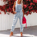 Women's cropped ripped denim overalls by FitiqueFit with strap bib detail, streetwear style, and distressed denim design.