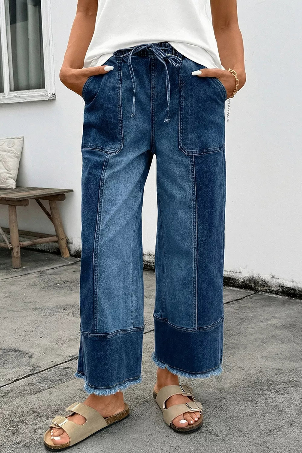Plush Fashion Hub wide-leg denim pants with drawstring waist, seam details, and raw hem, showcasing casual, relaxed style.