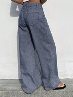 Striped wide-leg jeans by Shopimist shown on a model, featuring a high waist and bold vertical stripes in a casual streetwear style.