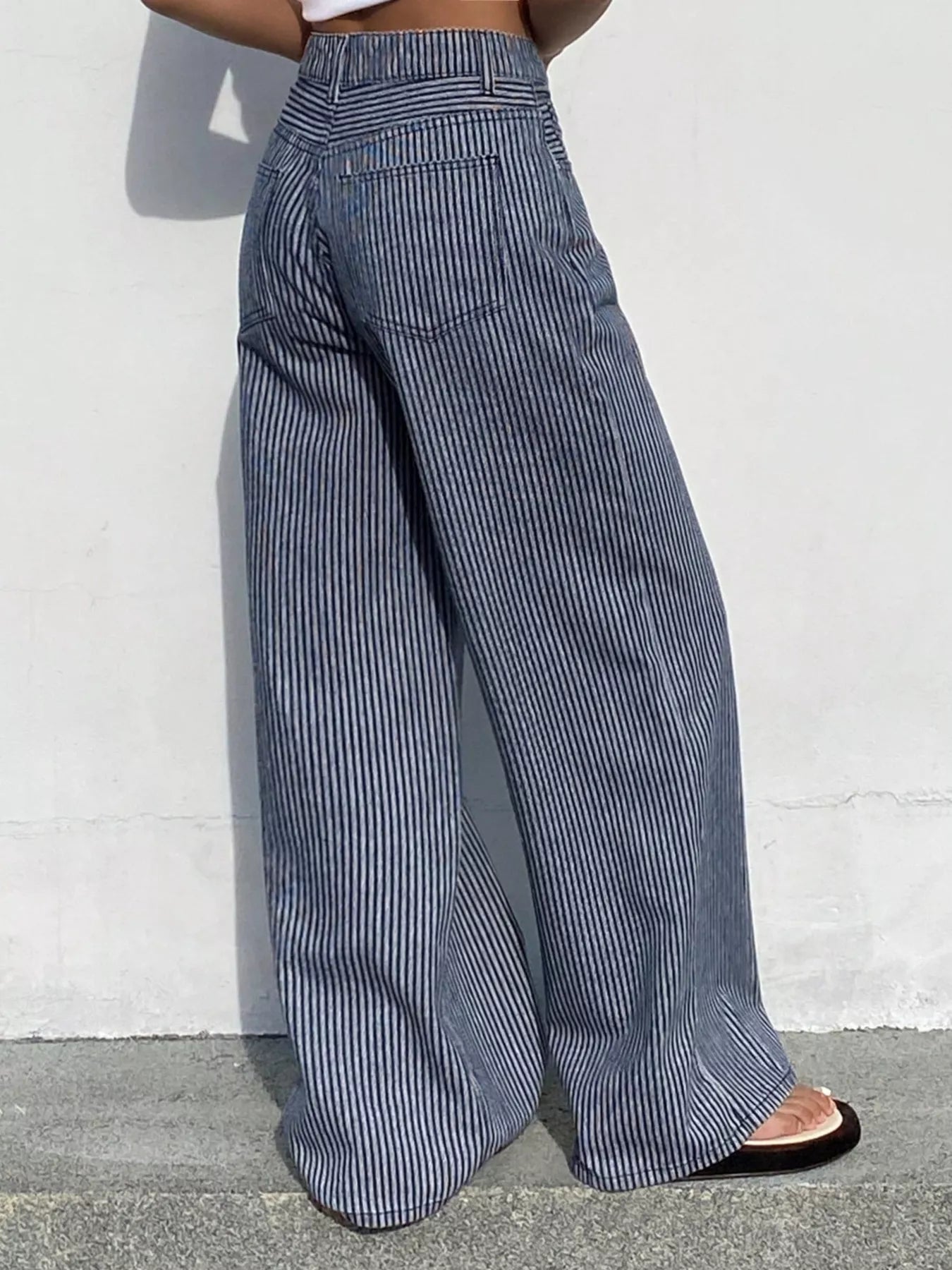 Striped wide-leg jeans by Shopimist shown on a model, featuring a high waist and bold vertical stripes in a casual streetwear style.