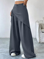 Asymmetrical wrap wide-leg pants by Plush Fashion Hub featuring flowing fabric and unique design in a stylish silhouette.