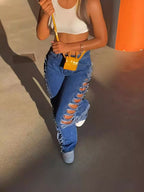 Plush Fashion Hub distressed denim jeans with side rips, slim fit, and classic five-pocket design on model.