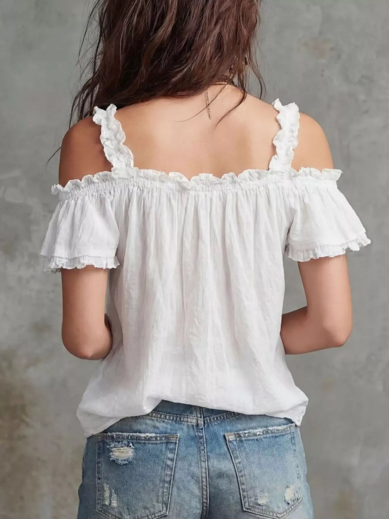 Plush Fashion Hub frill cold shoulder blouse with ruffled sleeves and relaxed fit, displayed on a hanger against a plain background.