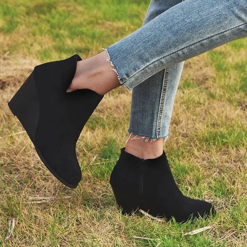 Black high heel ankle boots with side zipper, trendy footwear by Trendsi featuring a sleek design and pointed toe.