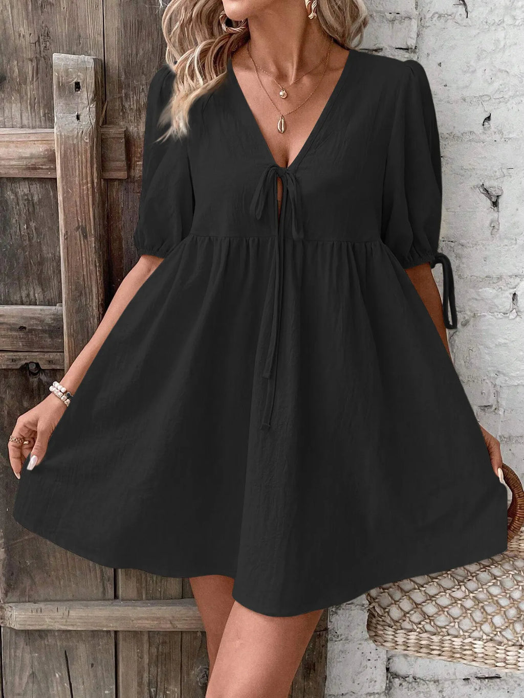 Cotton v-neck tie-front mini dress with puff sleeves, stylish and lightweight, perfect for casual or summer wear.