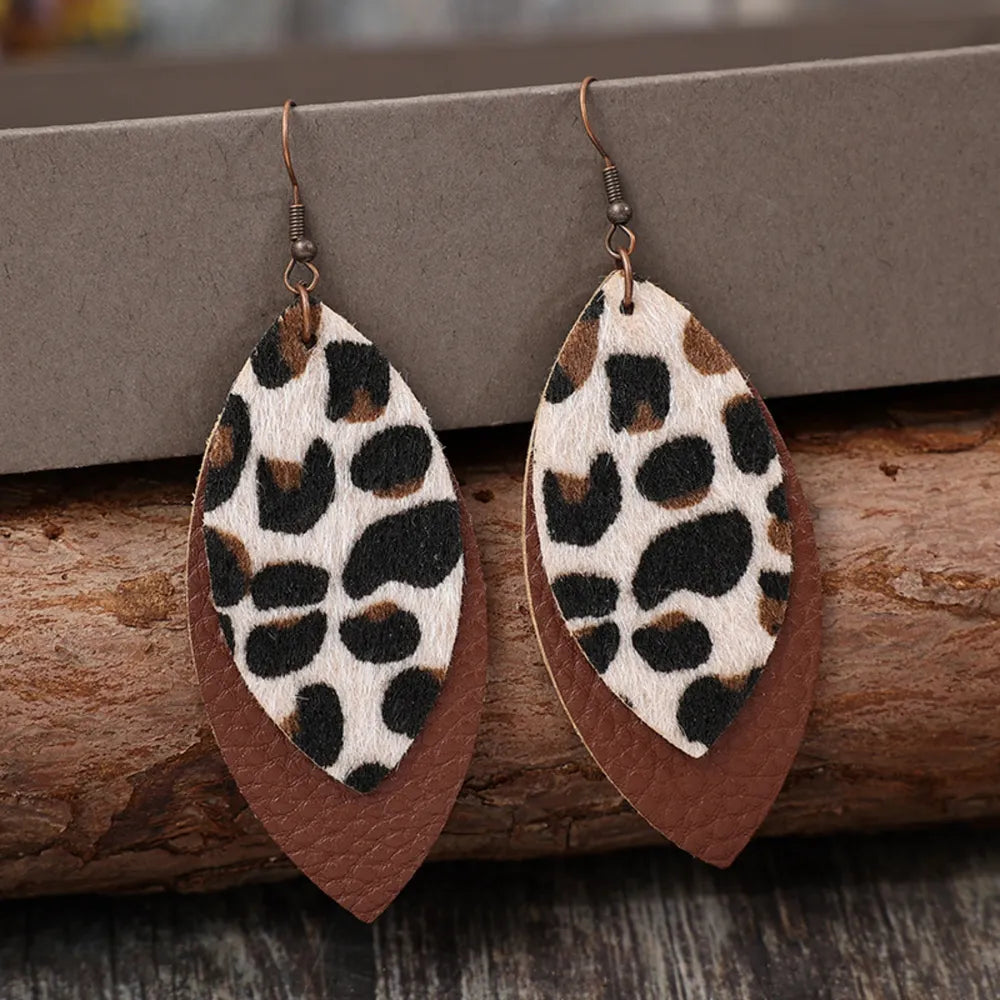 Leaf-shaped leather dangle earrings featuring plush design, stylish jewelry accessory for fashion or casual wear.