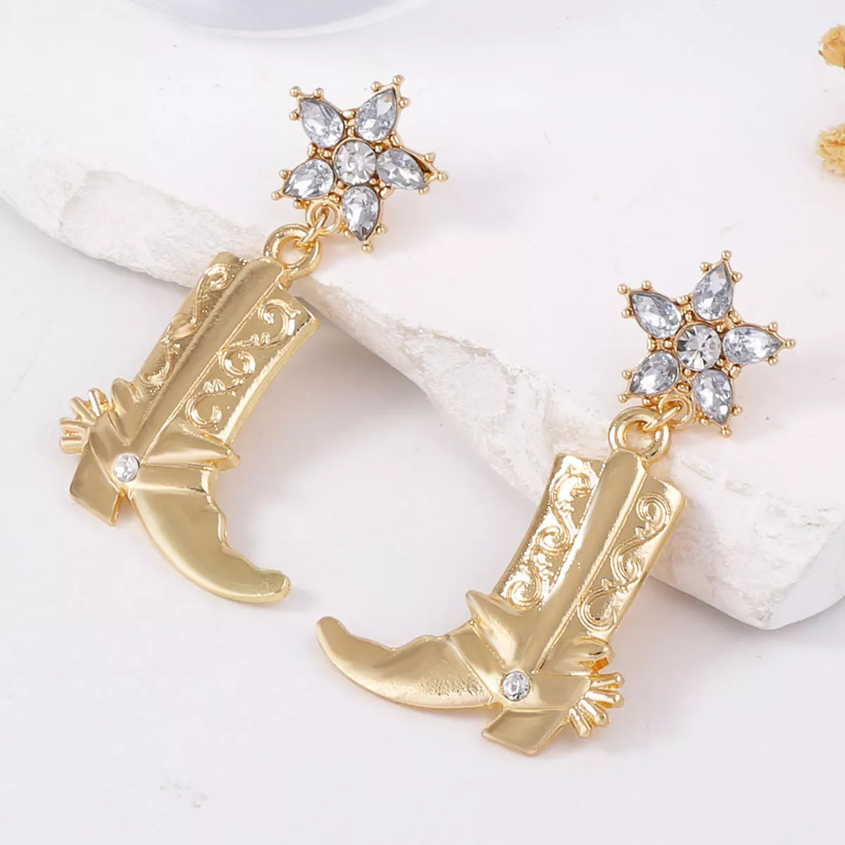 Western style dangle earrings with cowboy boot design from Plush Fashion Hub, featuring detailed metal accents and hanging style.