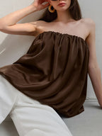 Women's strapless bubble hem tube top by Plush Fashion Hub, featuring a sleek minimalist design and trendy crop top style.