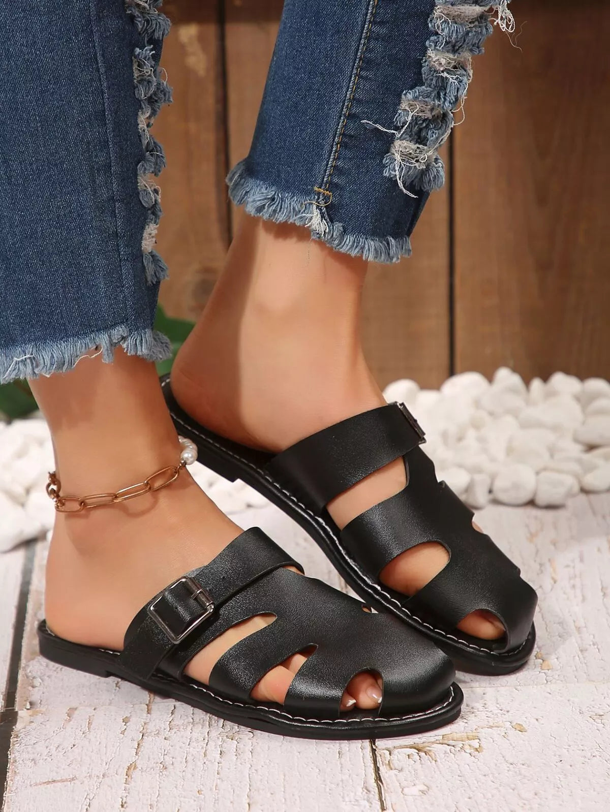 Comfortable slip-on leather sandals with adjustable buckle from Plush Fashion Hub, featuring a sleek design and cushioned footbed.