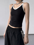 Black contrast trim cami top from Trendsi, featuring a fitted design with adjustable spaghetti straps and a sleek, stylish look.