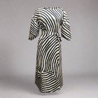Geometric print batwing sleeve flowy maxi dress by Plush Fashion Hub, casual wear, styled in a flowing fabric with a vibrant geometric pattern.