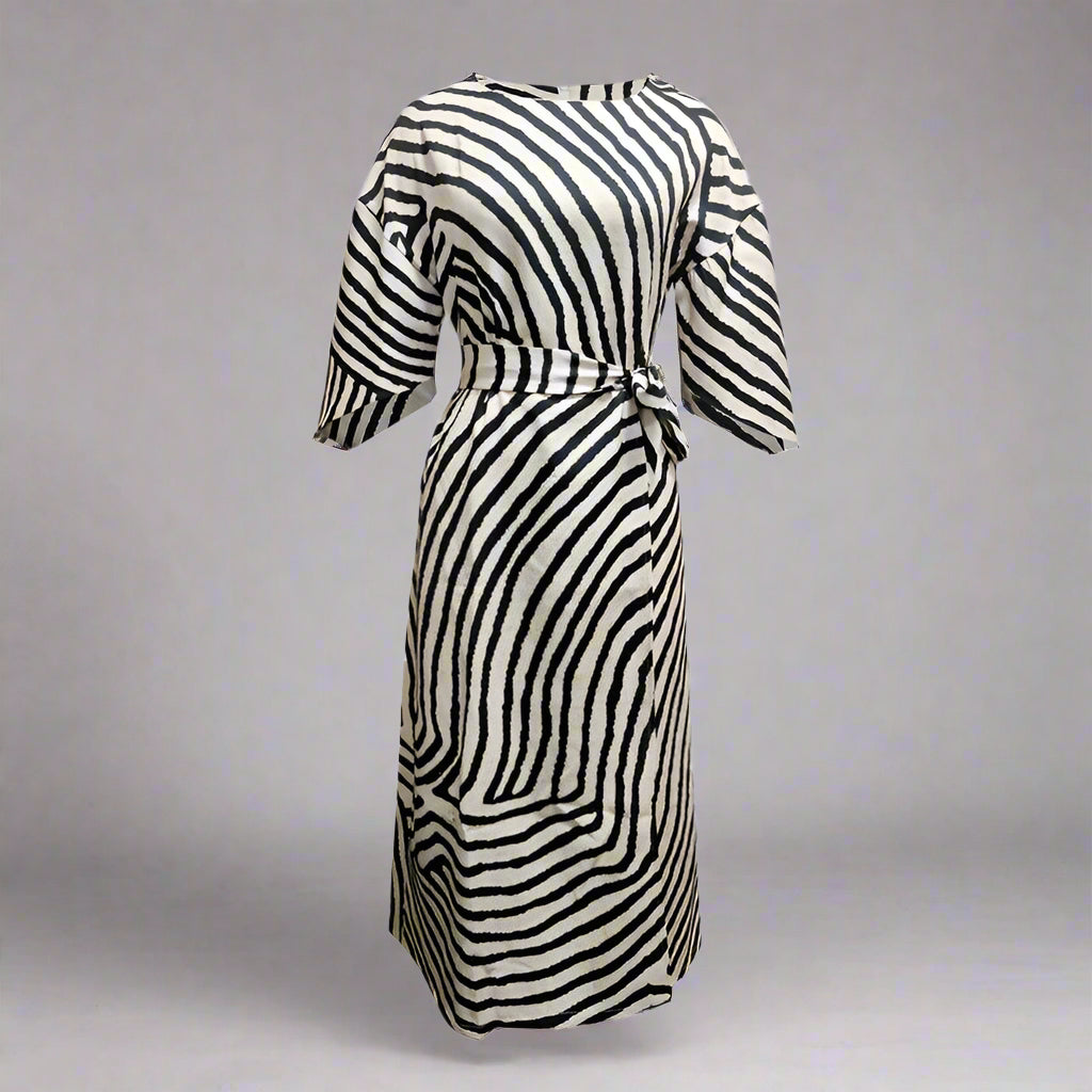 Geometric print batwing sleeve flowy maxi dress by Plush Fashion Hub, casual wear, styled in a flowing fabric with a vibrant geometric pattern.