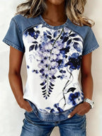 Denim patchwork short sleeve blouse from Plush Fashion Hub featuring mixed denim patches and a relaxed fit.
