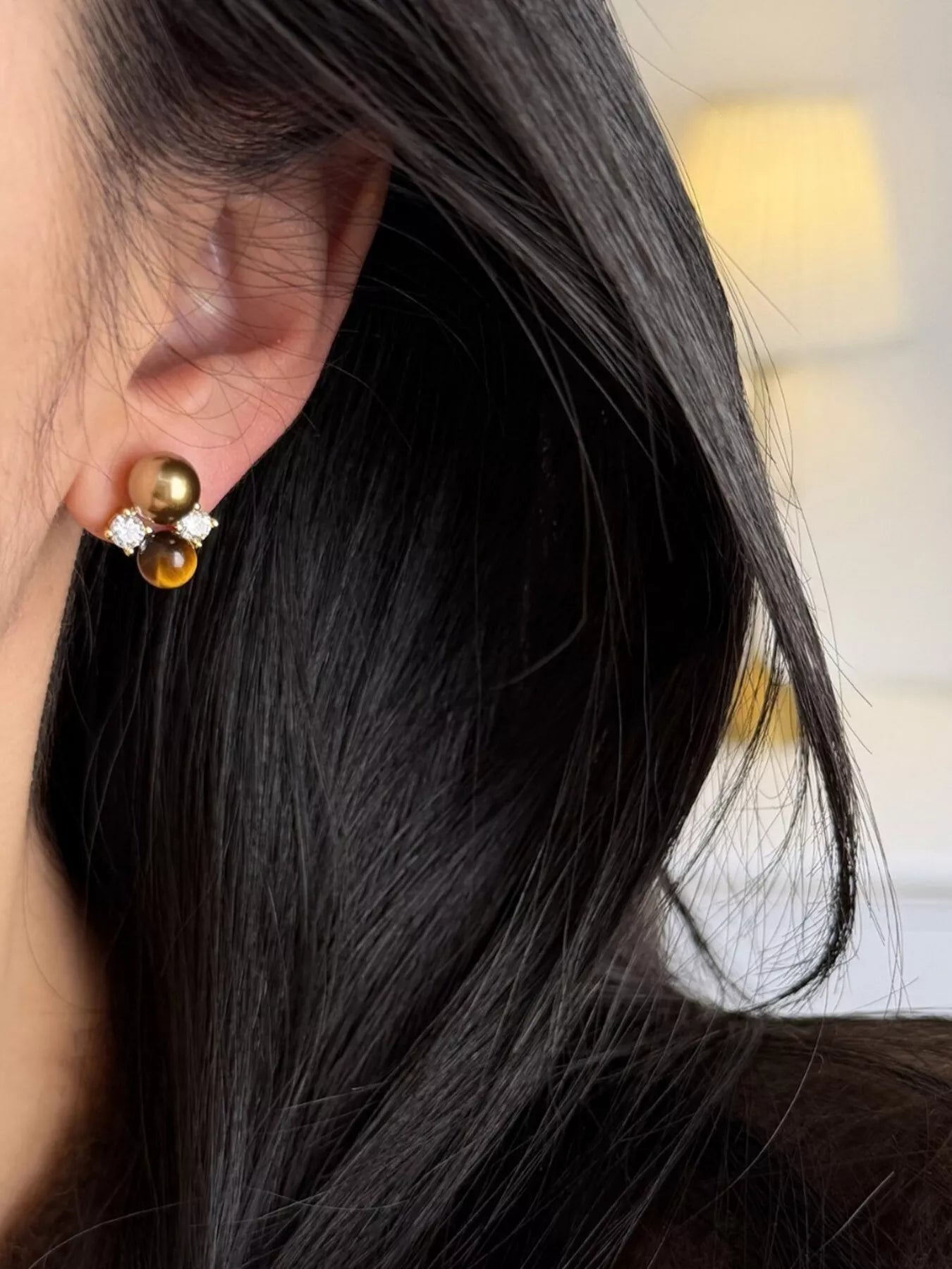 Tiger Eye stud earrings by Trendsi featuring polished oval-shaped gemstone earrings with gold-tone settings.