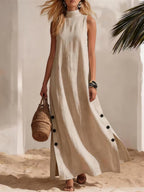 FitiqueFit sleeveless midi dress with side slits and loose fit, shown on a model in a casual indoor setting.
