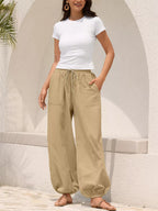 Casual loose fit harem joggers with drawstring waist in soft fabric, featuring a relaxed style and trendy design by Trendsi.