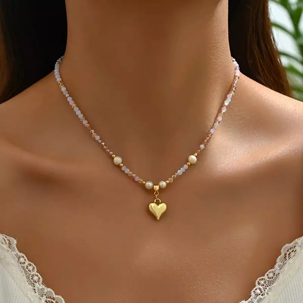 Bead heart pendant necklace by Plush Fashion Hub featuring colorful beads and a delicate chain on a white background.