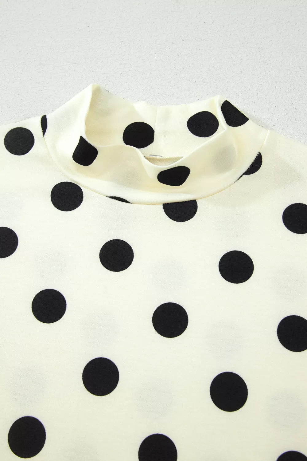 Polka dot print high neck dolman top by Plush Fashion Hub, showcasing its stylish design and comfortable fit.