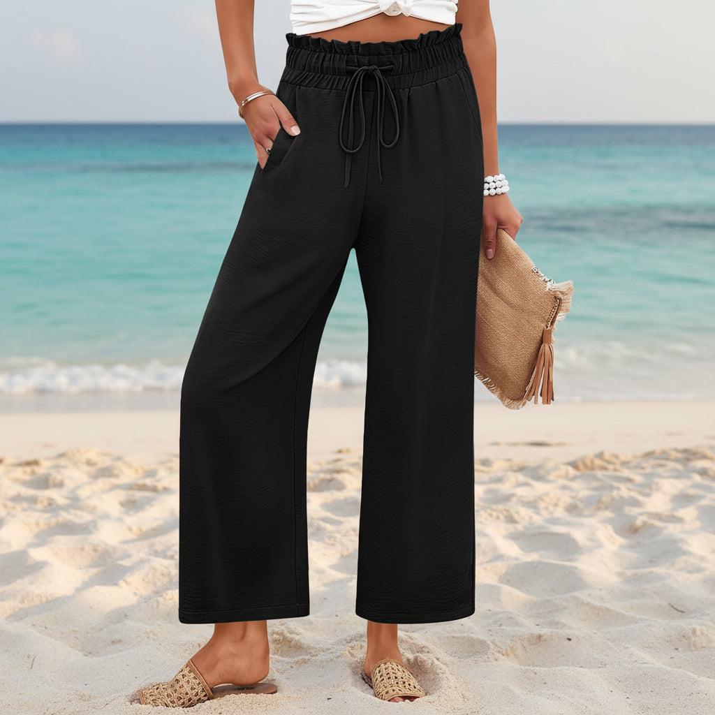 Women's wide-leg cropped pants by FitiqueFit with lace trim and pocket details, shown in a relaxed fit and lightweight fabric.