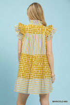 Umgee Mix Patchwork Flutter Sleeve Tiered Dress with boho style, showcasing colorful patchwork fabric and flowing silhouette.