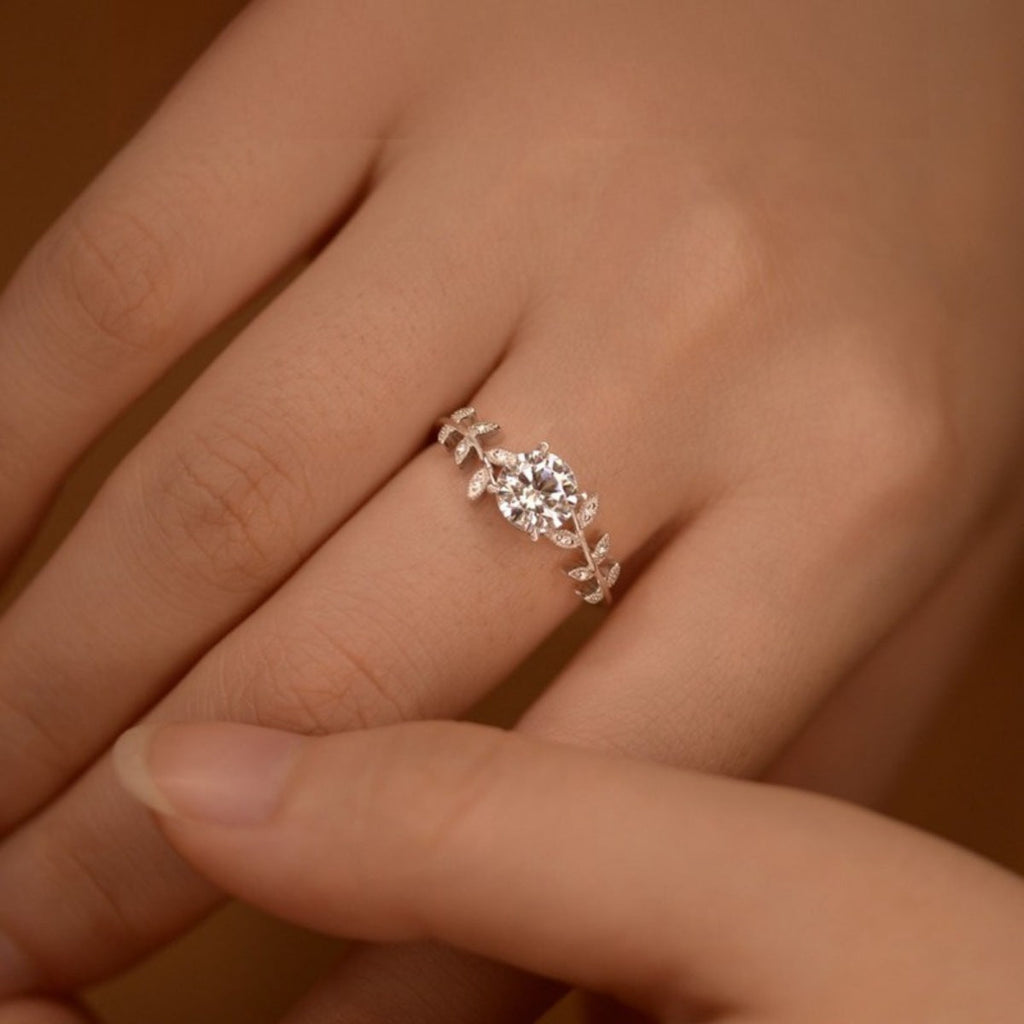 Sterling silver leaf ring with a 1-carat moissanite gemstone, featuring detailed leaf design and elegant craftsmanship.