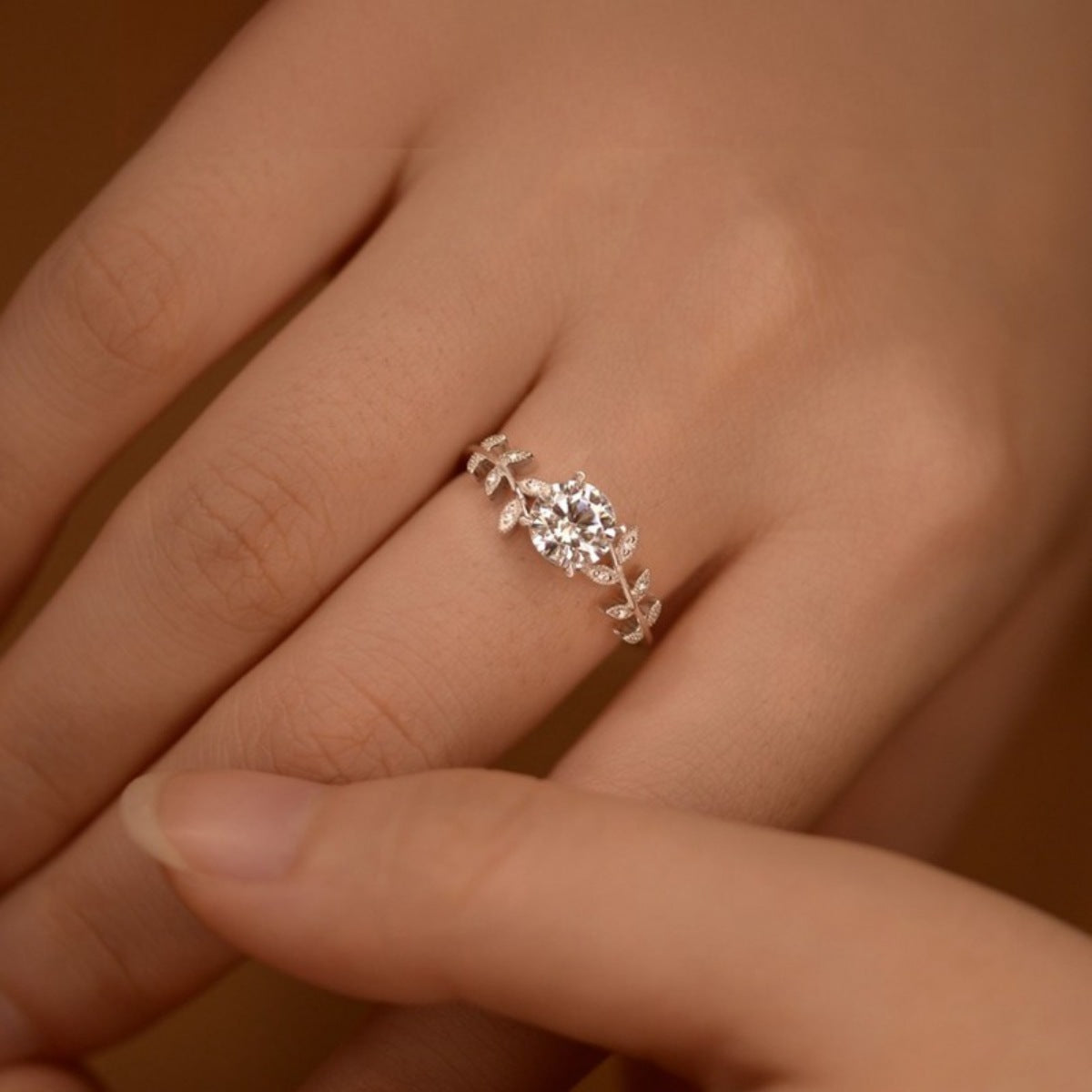 Sterling silver leaf ring with a 1-carat moissanite gemstone, featuring detailed leaf design and elegant craftsmanship.