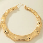 Stainless steel textured hoop earrings with a polished finish, stylish accessories with a modern, sleek design.