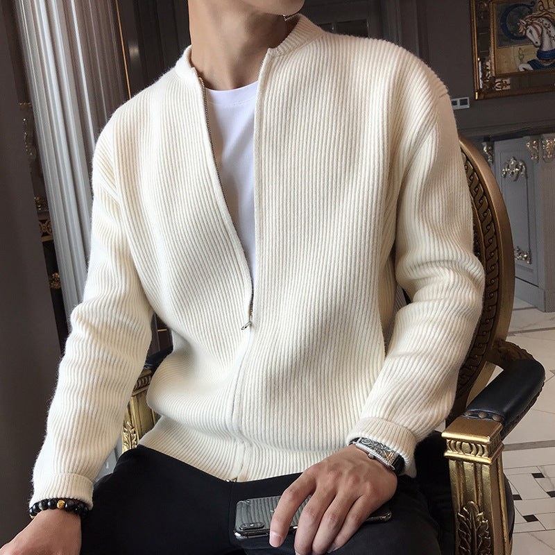 A man wearing a ribbed off-white knit cardigan with a full front zipper over a white t-shirt.