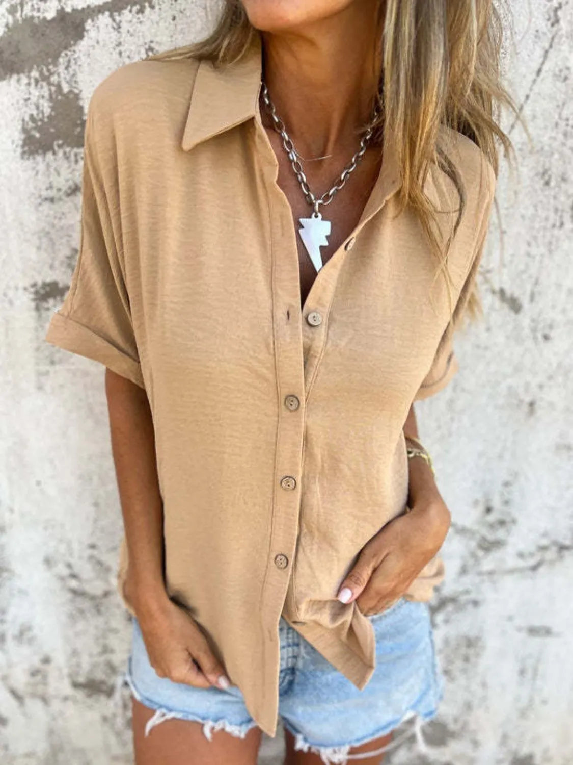Women's collared half sleeve button-down blouse by Trendsi, featuring a sophisticated office top with a classic collar and stylish design.