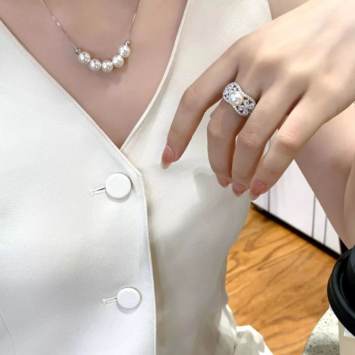 Adjustable pearl necklace from Plush Fashion Hub featuring white pearls on a delicate chain, styled for elegant wear.