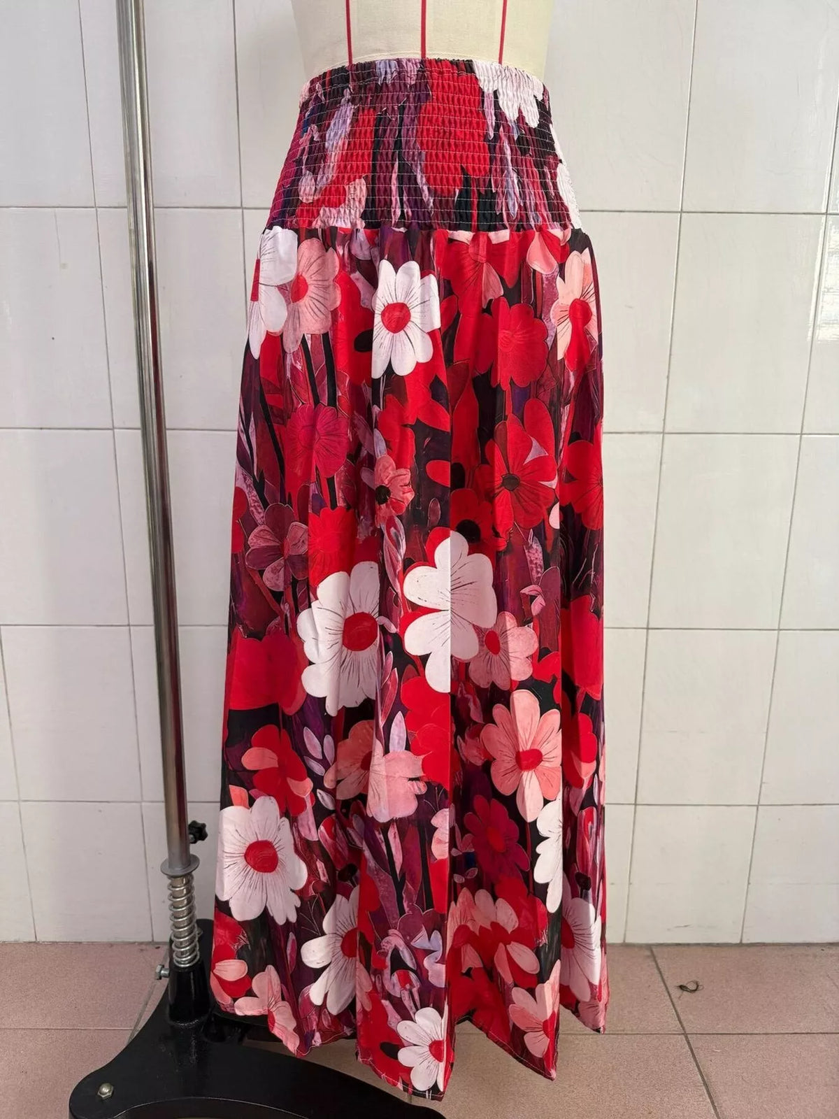 Floral print high-waisted maxi skirt from Trendsi featuring flowing fabric and vibrant flower design.