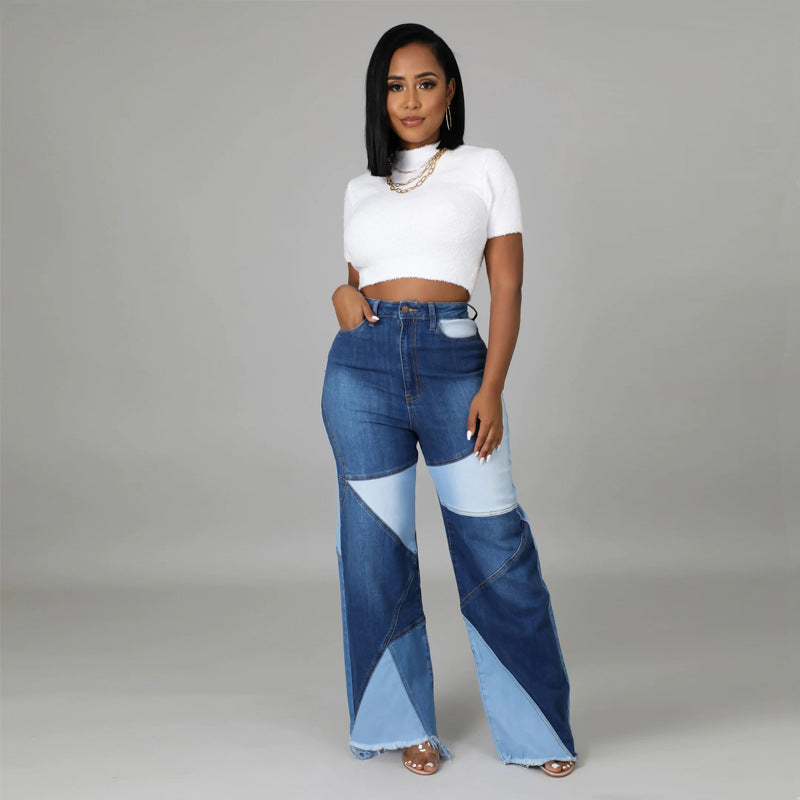 Model wearing high-waisted denim patchwork jeans in dark and light blue, paired with a white knit crop top.