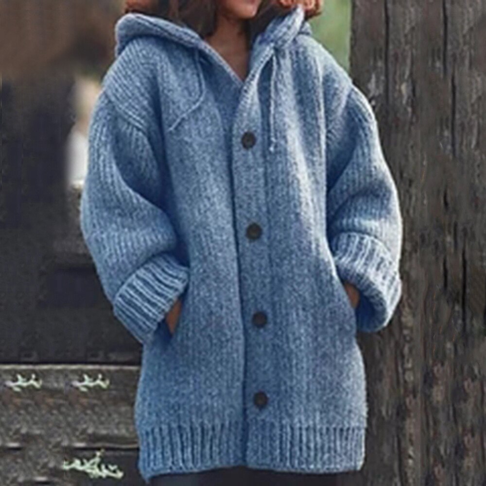 Blue, chunky knit cardigan with a hood, front buttons, side pockets, and ribbed cuffs.