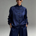 Women's satin two-piece set featuring a frog button jacket and wide-leg pants from Plush Fashion Hub, stylish and comfortable.