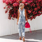 Women's cropped ripped denim overalls by FitiqueFit featuring streetwear strap bib design and distressed detailing.